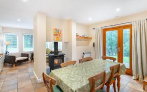 a dining room with a table and a fireplace at 1 Bed in Skelwith Bridge oc-lr159 in Elterwater +8 photos