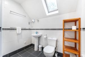 a white bathroom with a toilet and a sink at 1 Bed in Skelwith Bridge oc-lr159 in Elterwater