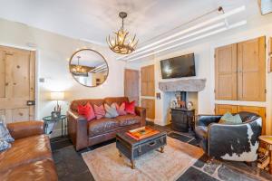 a living room with a leather couch and a table at 3 Bed in Windermere oc-lr164 in Windermere
