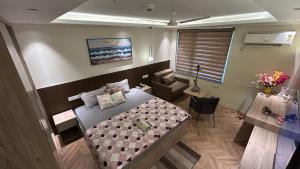 a bedroom with a bed and a chair and a desk at Bee Home Stay in Greater Noida