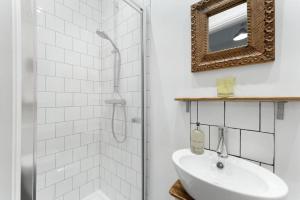 a white bathroom with a sink and a shower at 3 Bed in Coniston oc-lr198 in Coniston +20 photos