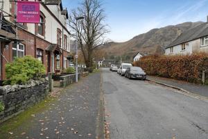a street in a town with cars parked on the road at 3 Bed in Coniston oc-lr198 in Coniston