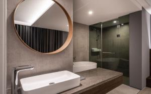a bathroom with a sink and a mirror at H hotel Gasan in Seoul