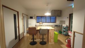 a kitchen with a wooden table and two chairs at Okawaya - Vacation STAY 49372v in Ōkawa +8 photos
