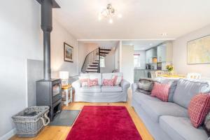 a living room with a couch and a stove at 2 Bed in Ambleside oc-lr114 in Chapel Stile