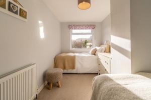 a small bedroom with two beds and a window at 2 Bed in Ambleside oc-lr114 in Chapel Stile