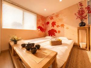 a bedroom with a bed and a table with vases on it at 刻宿Toki Stay Ueno in Tokyo