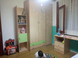 a child is playing in a room with a bedroom at Cal Bonet in Cerviá