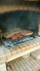 a grill with some meat and sausages on at Cal Bonet in Cerviá