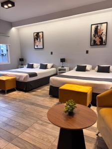 a hotel room with two beds and a couch at HOTEL CITY in Posadas +50 photos