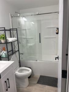 a white bathroom with a shower and a toilet at AYBAM's House in Winnipeg +30 photos