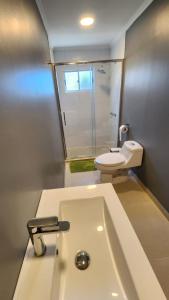 a bathroom with a white sink and a toilet at Hostal HDQ en Concepción Sector Collao in Concepción