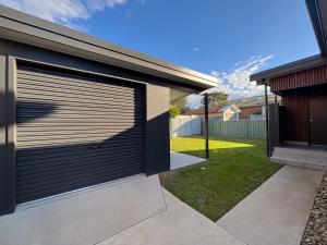 a garage door on the side of a house at Loveday on Landsborough in South West Rocks