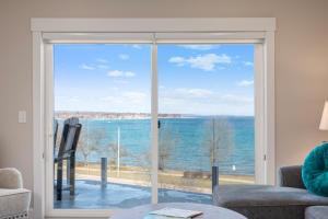 a living room with a view of the ocean at 539 Bay St ⁀➷ 3BDR Lake View Penthouse Condo on West Bay ➠ 401W in Traverse City