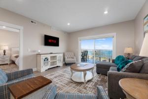 a living room with a couch and a table at 539 Bay St ⁀➷ 3BDR Lake View Penthouse Condo on West Bay ➠ 401W in Traverse City