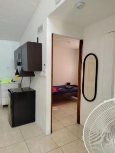 a room with a mirror and a room with a bed at El Gato de la Jungla in Lagunillas