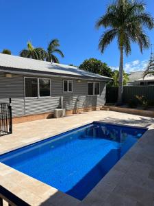 a swimming pool in front of a house at Billfish in Exmouth