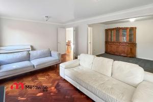 a living room with two white couches at Spacious 4-Bedroom Home in Cherrybrook in Cherrybrook