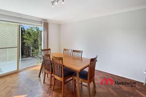 a dining room with a wooden table and chairs at Spacious 4-Bedroom Home in Cherrybrook in Cherrybrook +7 photos