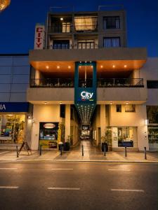 a building with a city sign on the side of it at HOTEL CITY in Posadas