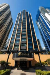 a tall building with a sign in front of it at Sol Alphaville Hotel By Your Alpha Stay 1602 in Barueri