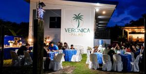 a group of people sitting at tables at a event at Veronica Palms in Pooc