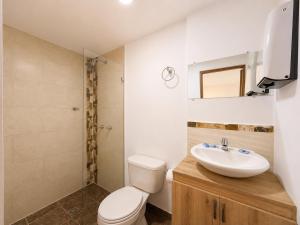 a bathroom with a toilet and a sink at Hotel Laureles Palo Alto in Medellín +37 photos