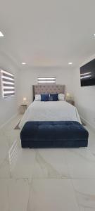 a bedroom with a large bed in a white room at Hard Rock Area Modern Studio in Miami Gardens