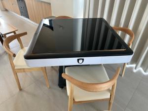 a table with a laptop on top of a chair at wangderfu享富Villa in Dongshan +3 photos
