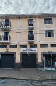 a building with two garage doors and two balconies at Urban Colonial in Quito