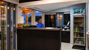 a man sitting at a bar in a restaurant at The Tree House Port Vila in Port Vila