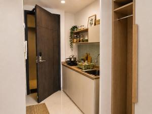 a small kitchen with a counter and a sink at Loft Privato, Jakarta in Jakarta