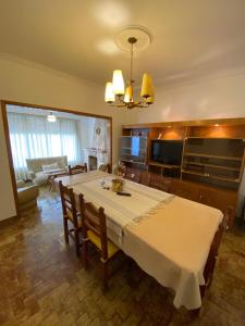 a dining room with a table and a living room at Espacio Patagonico in Comodoro Rivadavia +7 photos