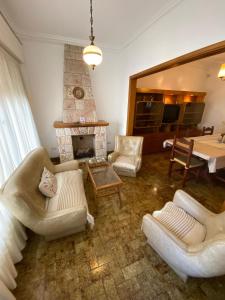 a living room with white furniture and a fireplace at Espacio Patagonico in Comodoro Rivadavia