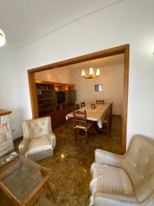 a living room with a table and chairs and a mirror at Espacio Patagonico in Comodoro Rivadavia