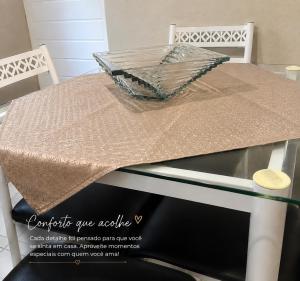 a glass table with a table cloth on top of it at Aconchego in Fortaleza