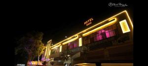 a building with neon lights on the side of it at Hotel soni plaza in Jhālrapātan