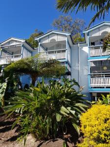 a row of blue apartment buildings with trees and plants at Moreton Island Villas and Apartments in Tangalooma