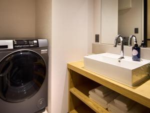 a bathroom with a washing machine and a sink at Minn Hakata Station East in Sumiyoshi