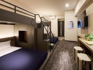 a hotel room with a bunk bed and a bathroom at Minn Hakata Station East in Sumiyoshi