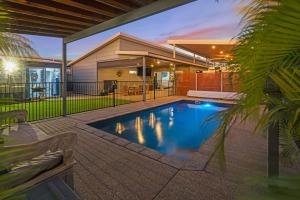 a swimming pool in the backyard of a house at Kingfisher in Exmouth