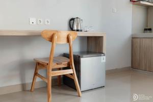 a wooden stool sitting in front of a kitchen counter at Double A Cozy Living in Canggu
