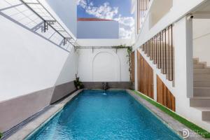 a swimming pool in the middle of a building at Double A Cozy Living in Canggu