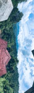 an aerial view of the sky with trees and clouds at Misty Hill Land in Meppādi