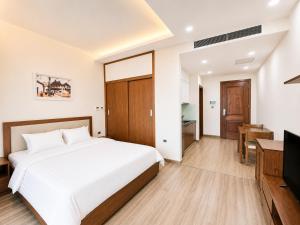 a bedroom with a bed and a television at Eco Nest Residence in Hanoi