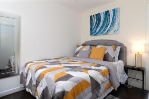 a bedroom with a bed with a colorful comforter at Comfort and Cozy stay Free parking on site in Oakland