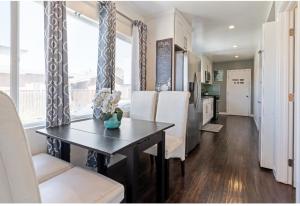 a dining room with a table and white chairs at Comfort and Cozy stay Free parking on site in Oakland