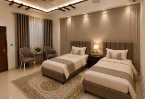 a bedroom with two beds and a table and chairs at Prime Stay Bosan Hotel Multan in Multan +14 photos