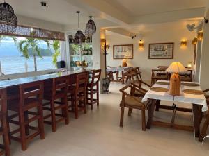 a restaurant with a bar with chairs and tables at Binucot Pearl Boutique Resort in Ferrol +41 photos
