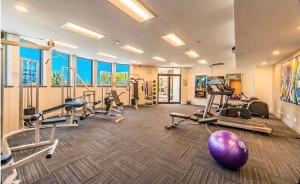 a gym with several treadmills and exercise machines at Stunning City View Beachfront Apartment in Gold Coast